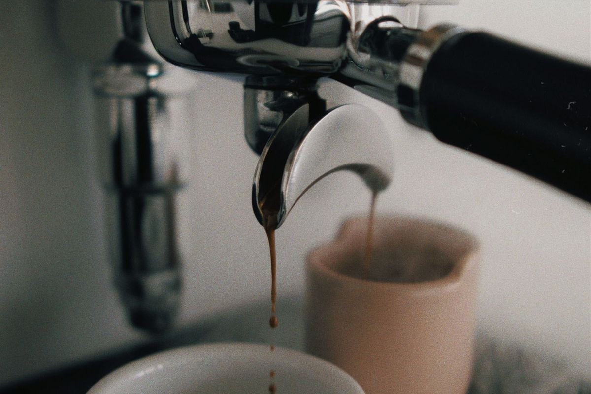Compact espresso machine brewing into a cup (representative photo, not the exact product)