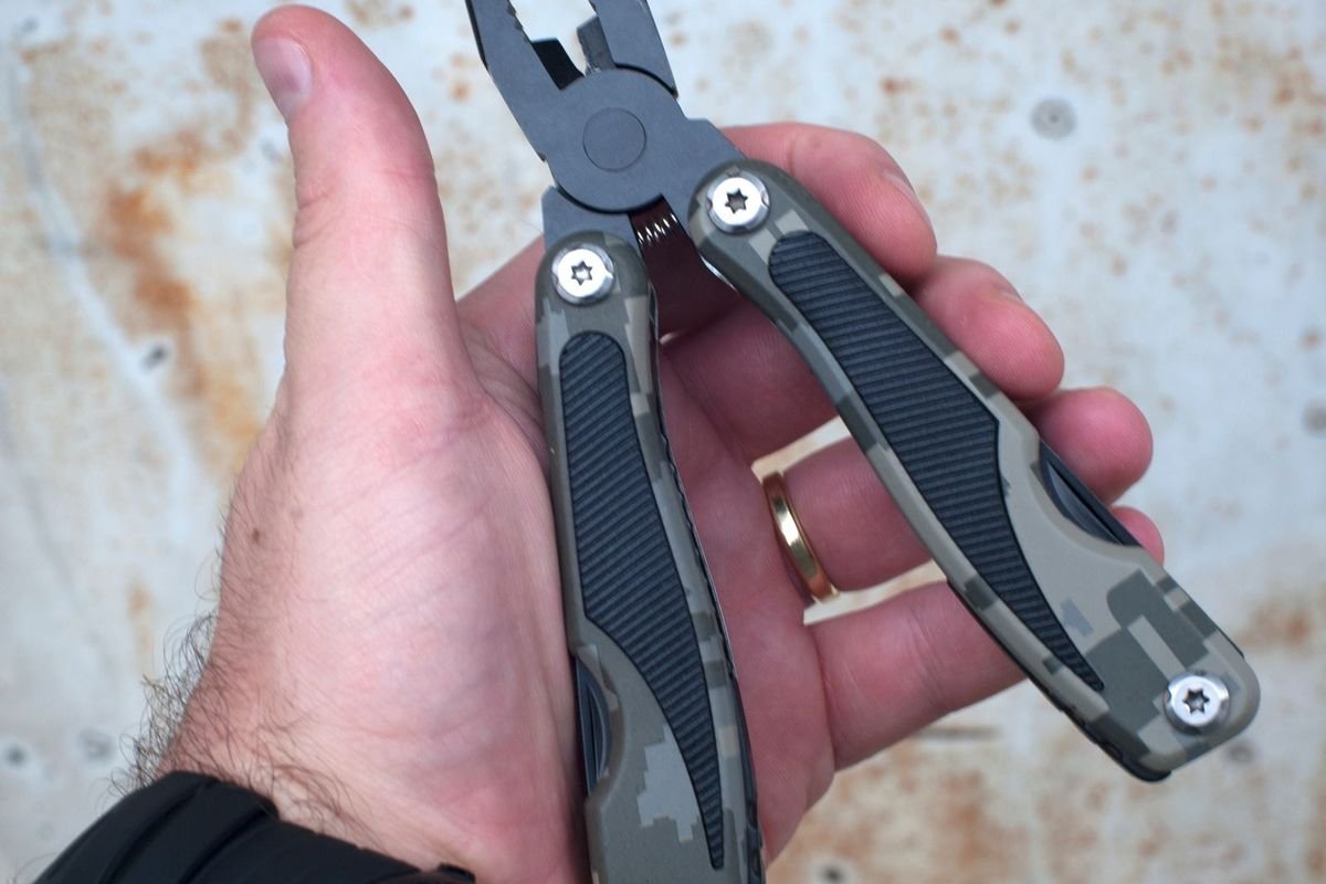 Hand holding an open multi-tool (representative photo, not the exact product)