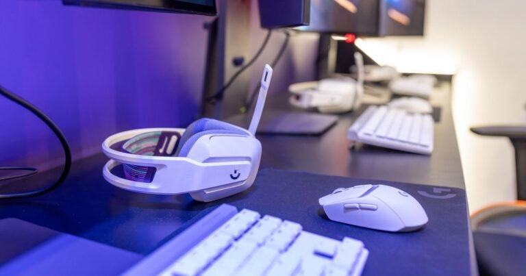 Close-up of a gaming setup with white headset, mouse and keyboard
