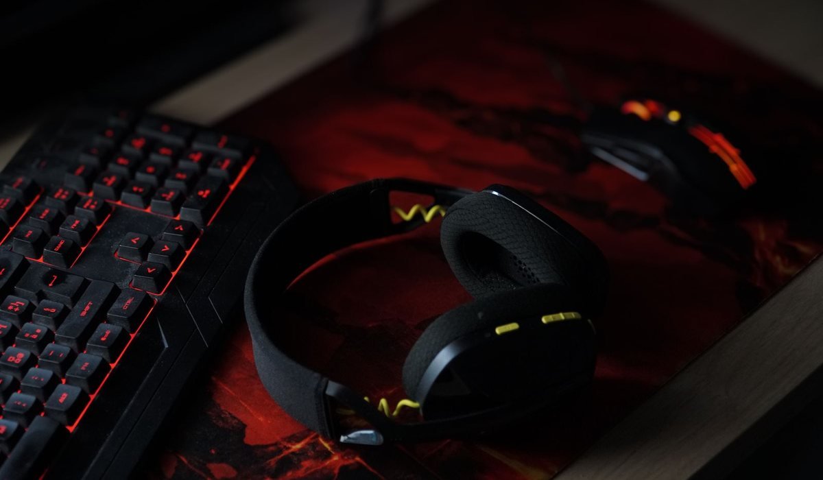 Wireless headphones resting on a backlit gaming keyboard