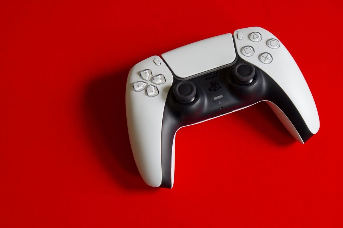 White game controller on a bold red background (representative photo, not the exact product)