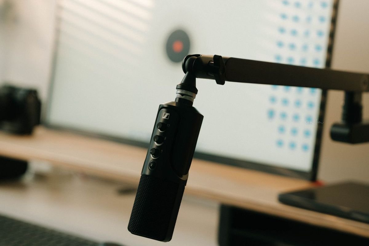 Home office desk with a mounted microphone and desktop computer (representative photo, not the exact product)