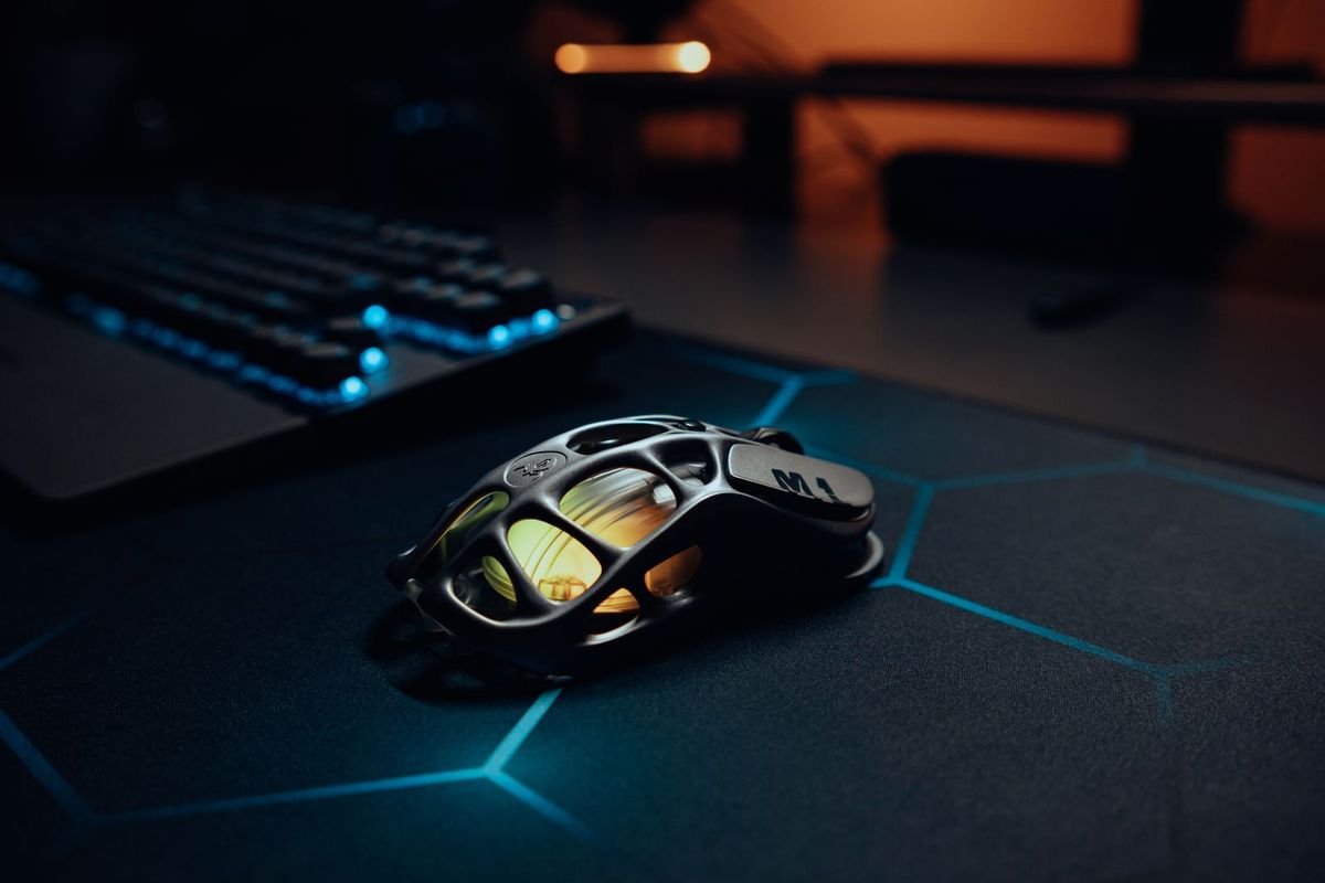 Gaming mouse on an RGB-lit desk (representative photo, not the exact product)