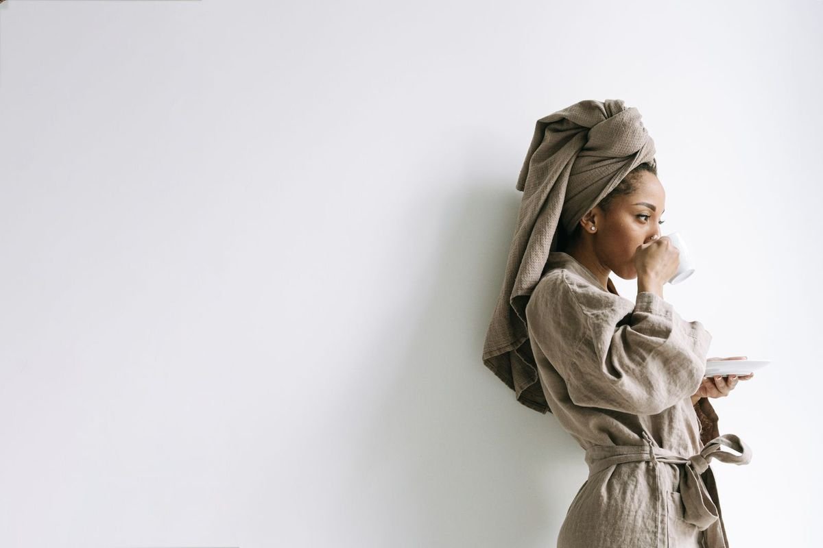Woman in a bathrobe enjoying a hot drink (representative photo, not the exact product)
