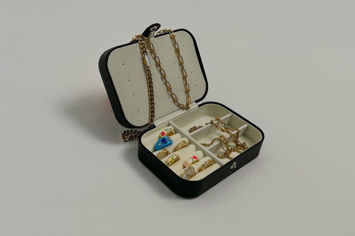 Black jewelry box with rings and a necklace (representative photo, not the exact product)