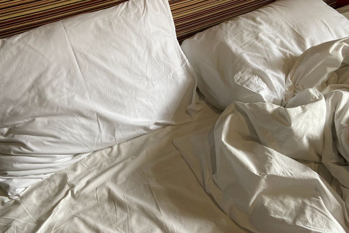 Bed with soft white linens and pillows (representative photo, not the exact product)