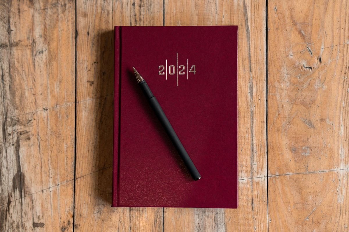 Pen on a planner on a wooden desk (representative photo, not the exact product)