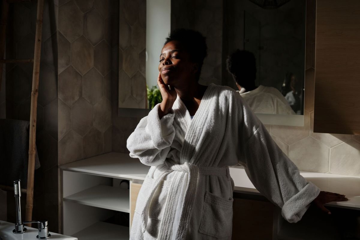 Woman in a white bathrobe (representative photo, not the exact product)