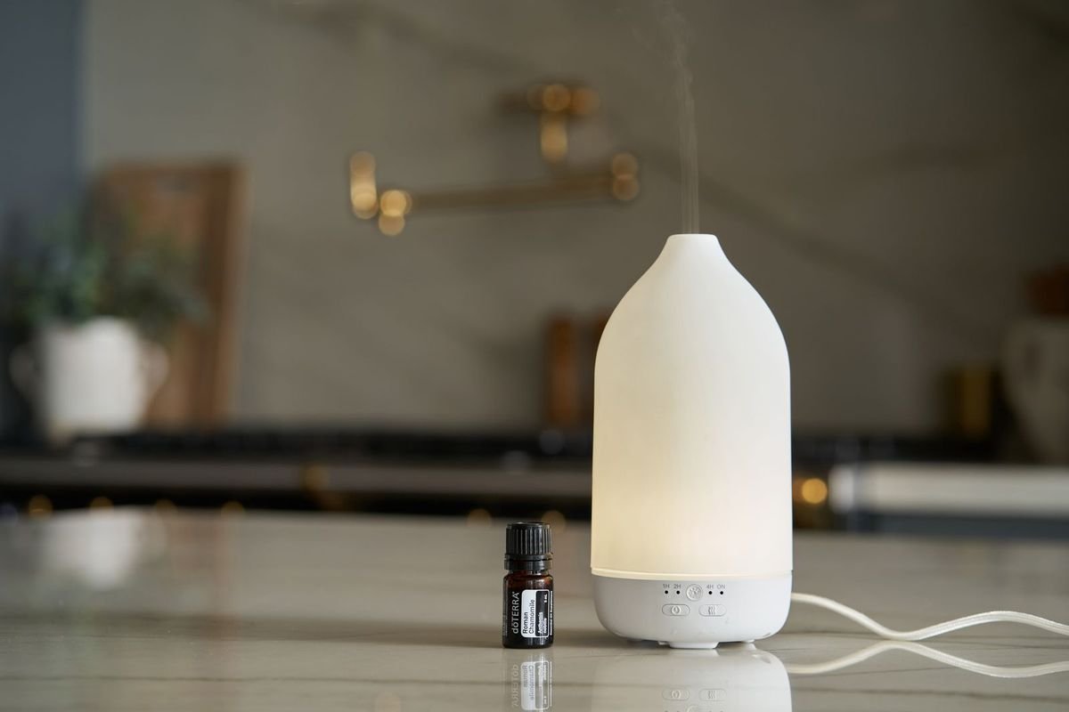 Essential oil bottle and diffuser in a kitchen (representative photo, not the exact product)