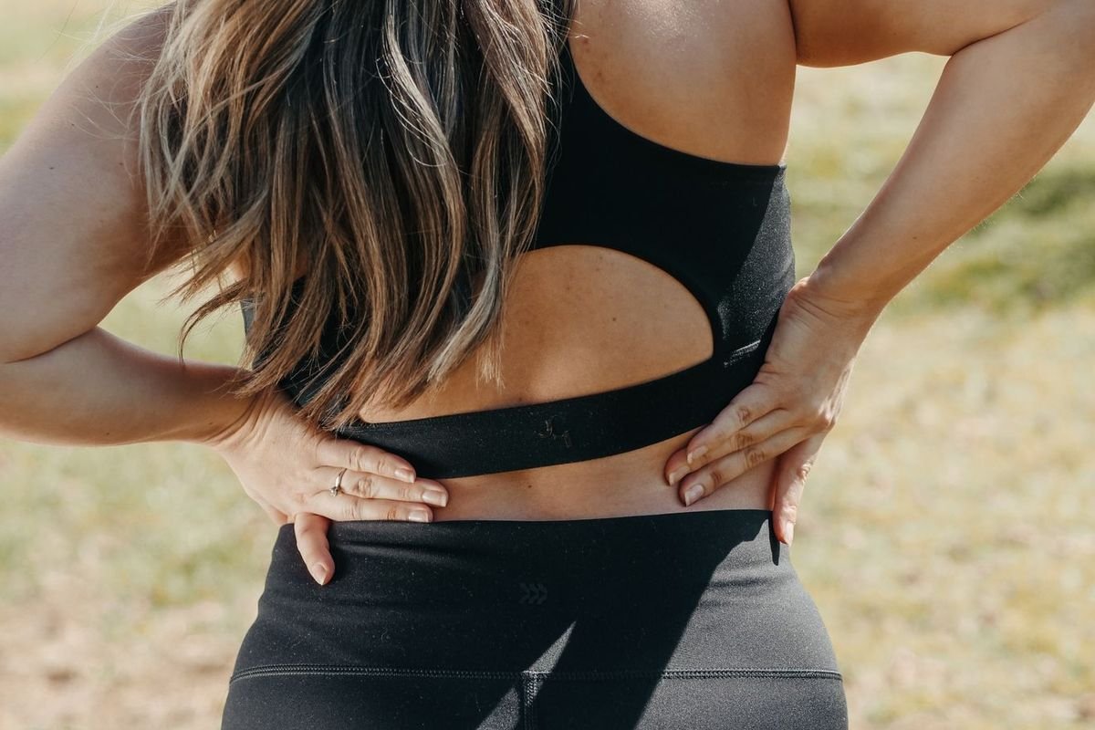 Woman holding her lower back (representative photo, not the exact product)
