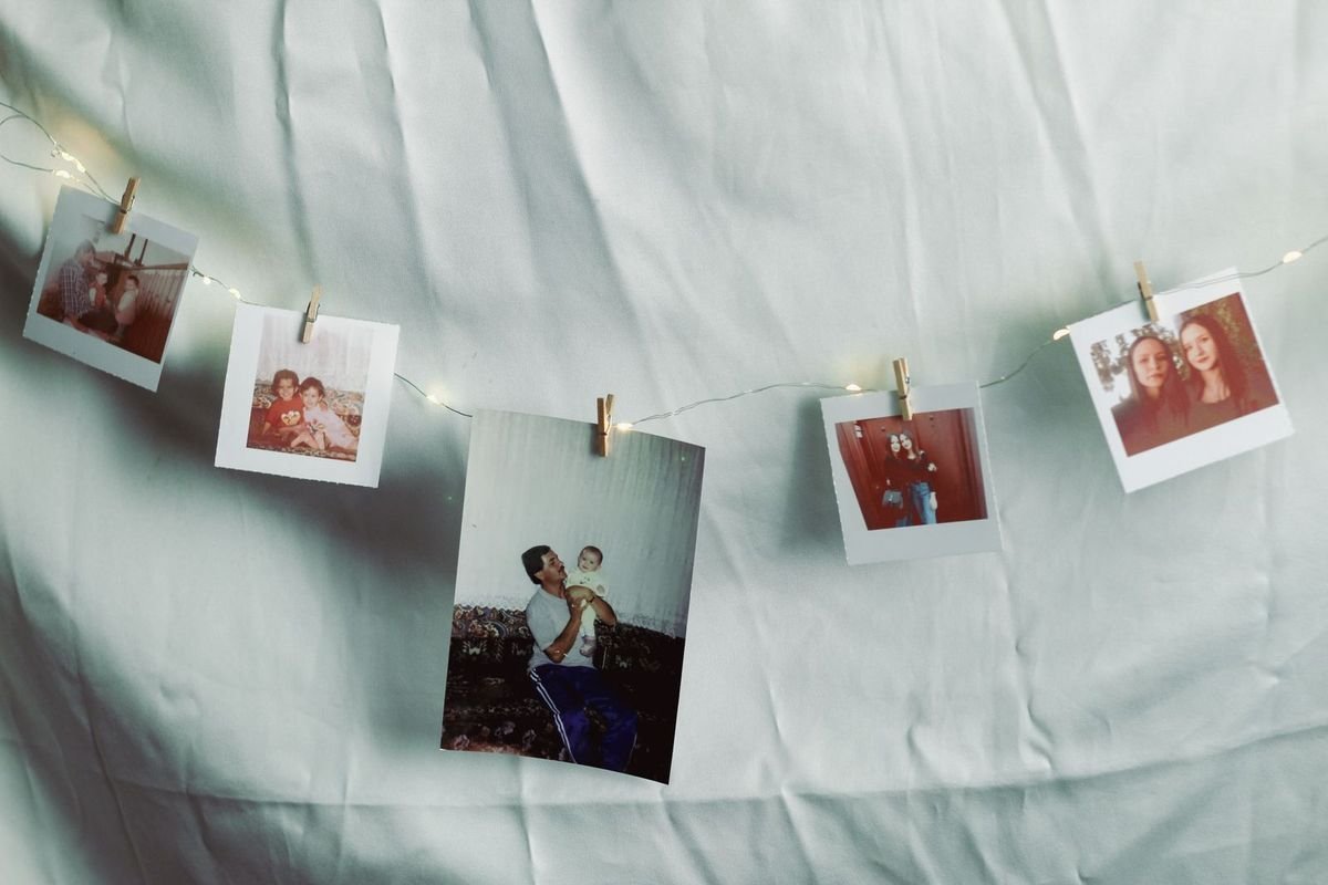 Family photos hung on string lights (representative photo, not the exact product)