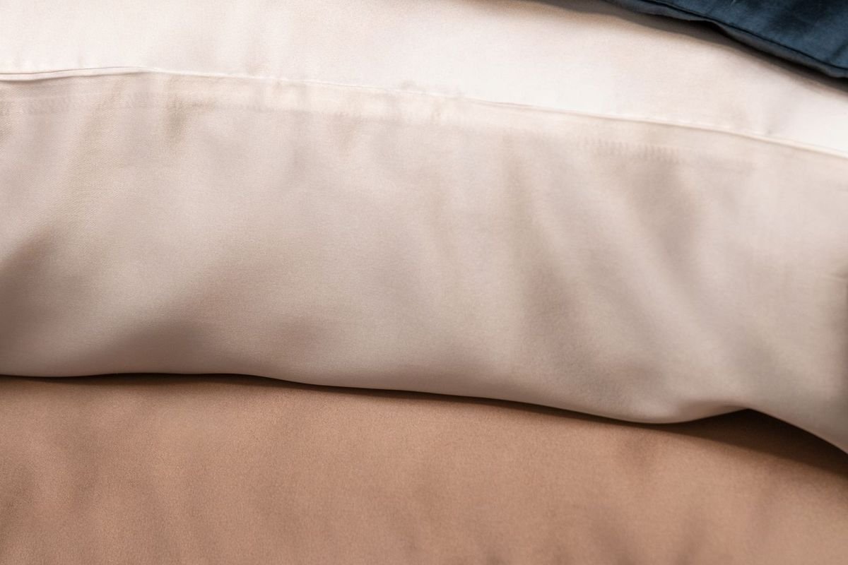 Stack of colorful silk pillowcases (representative photo, not the exact product)