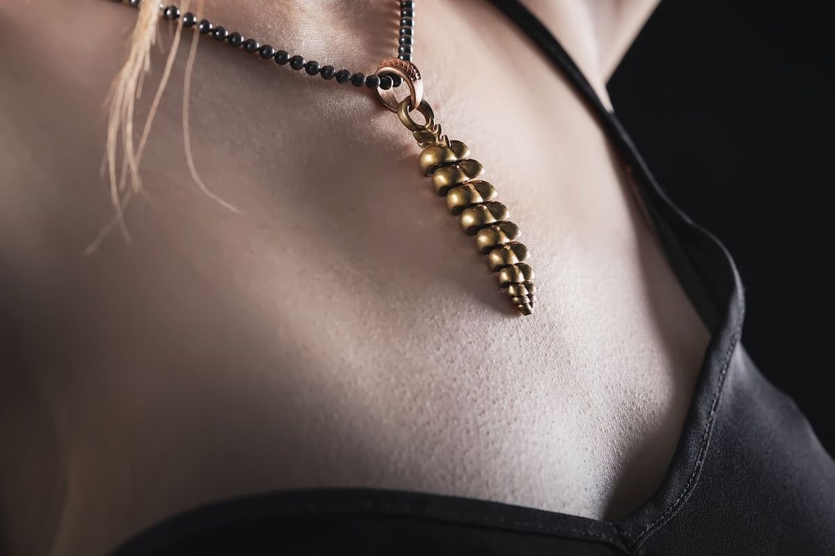 Close-up of a gold necklace worn on skin (representative photo, not the exact product)