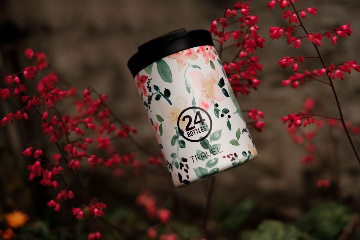 Reusable water bottle in front of red flowers (representative photo, not the exact product)