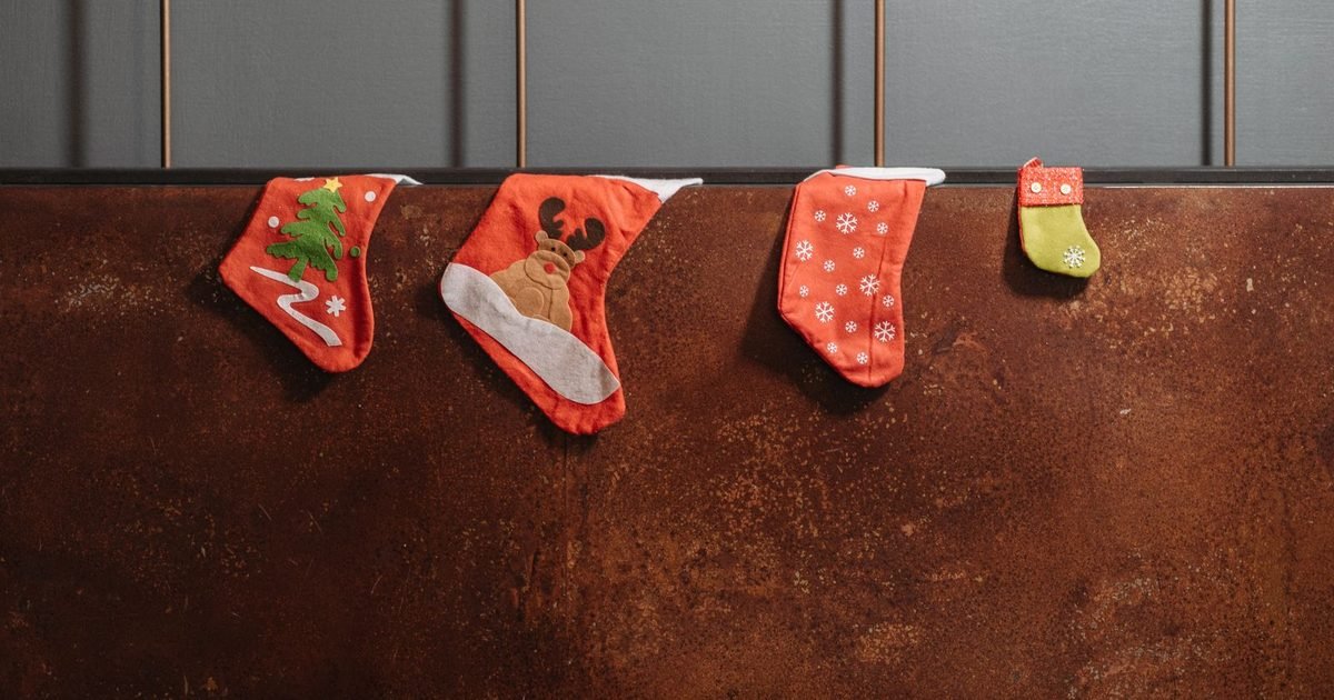 Four Christmas stockings hanging on a wall