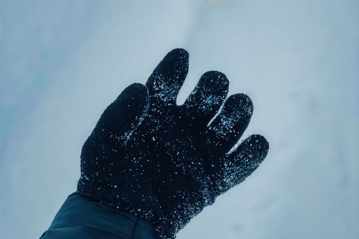 Hand in a winter glove in the snow (representative photo, not the exact product)