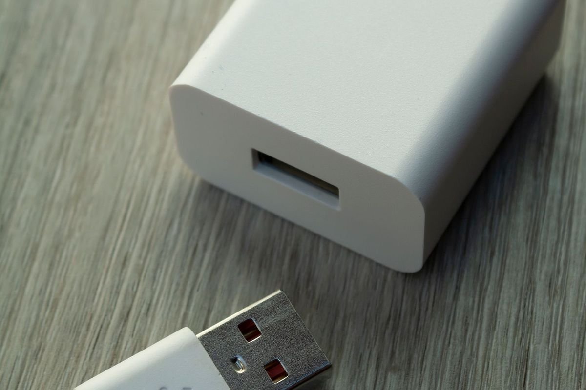Close-up of a white USB charger and cable (representative photo, not the exact product)
