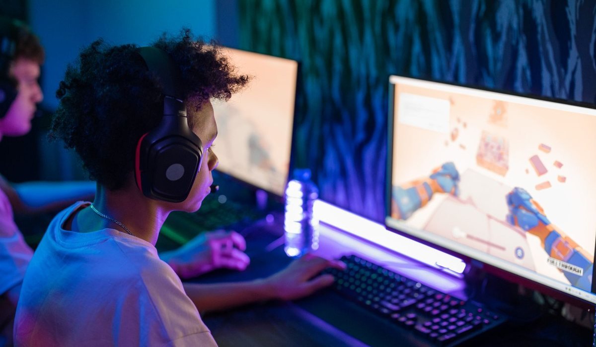 Teens playing computer games in a colorful gaming room