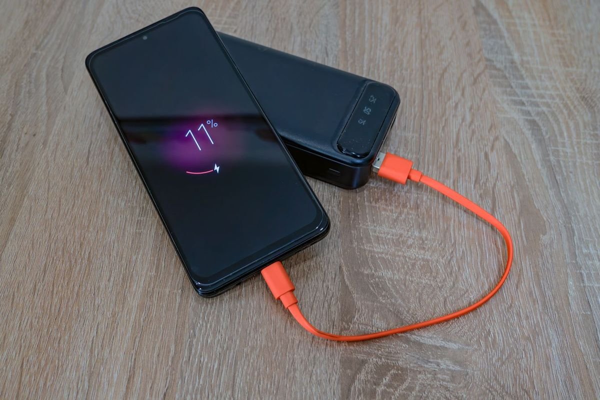 Smartphone charging from a power bank (representative photo, not the exact product)