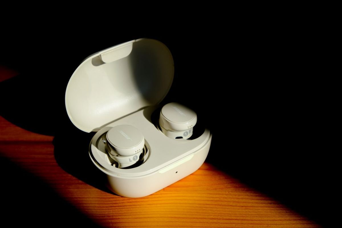 White wireless earbuds in a charging case (representative photo, not the exact product)