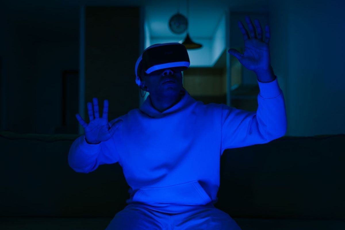 Man wearing a VR headset in a blue-lit room (representative photo, not the exact product)