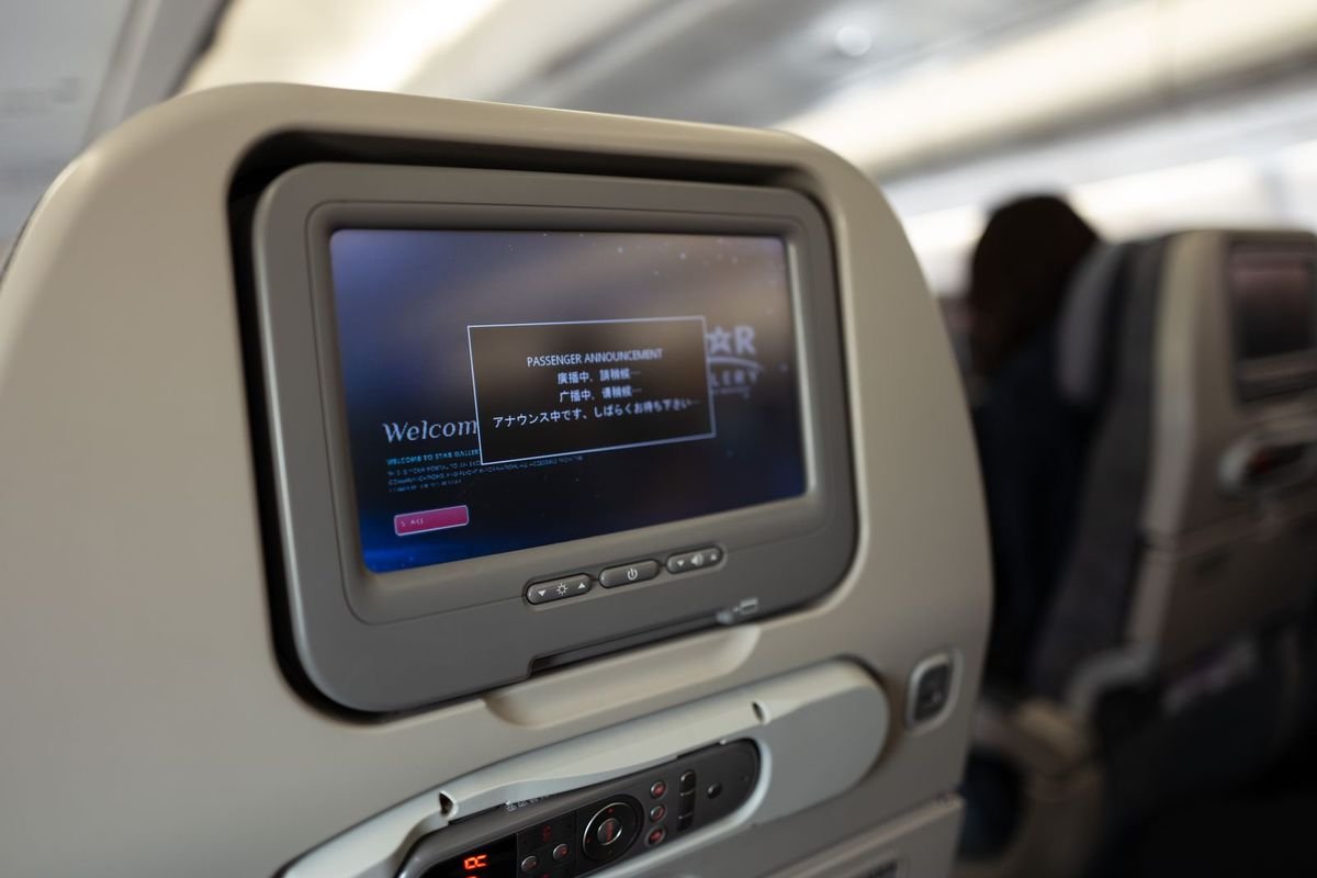 Airplane seatback screen in a passenger cabin (representative photo, not the exact product)