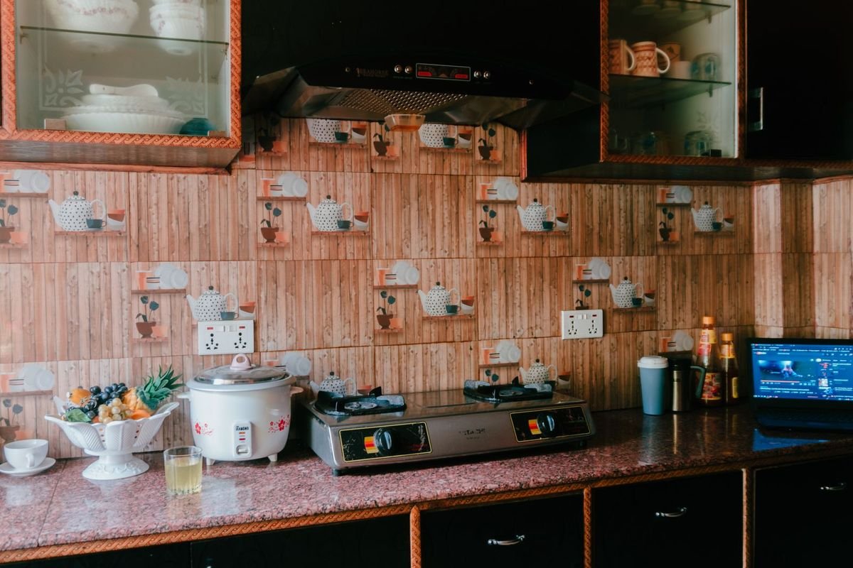 Kitchen counter with a stove and rice cooker (representative photo, not the exact product)