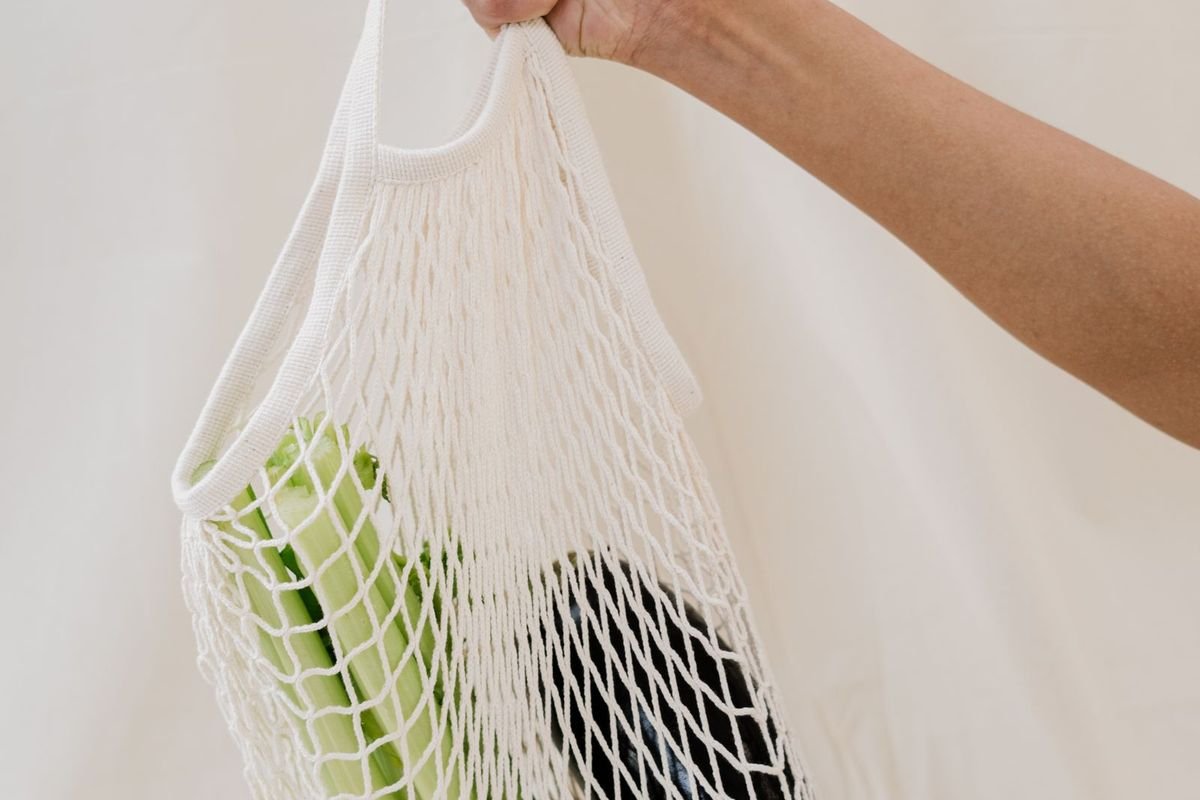 Person holding a reusable net bag (representative photo, not the exact product)