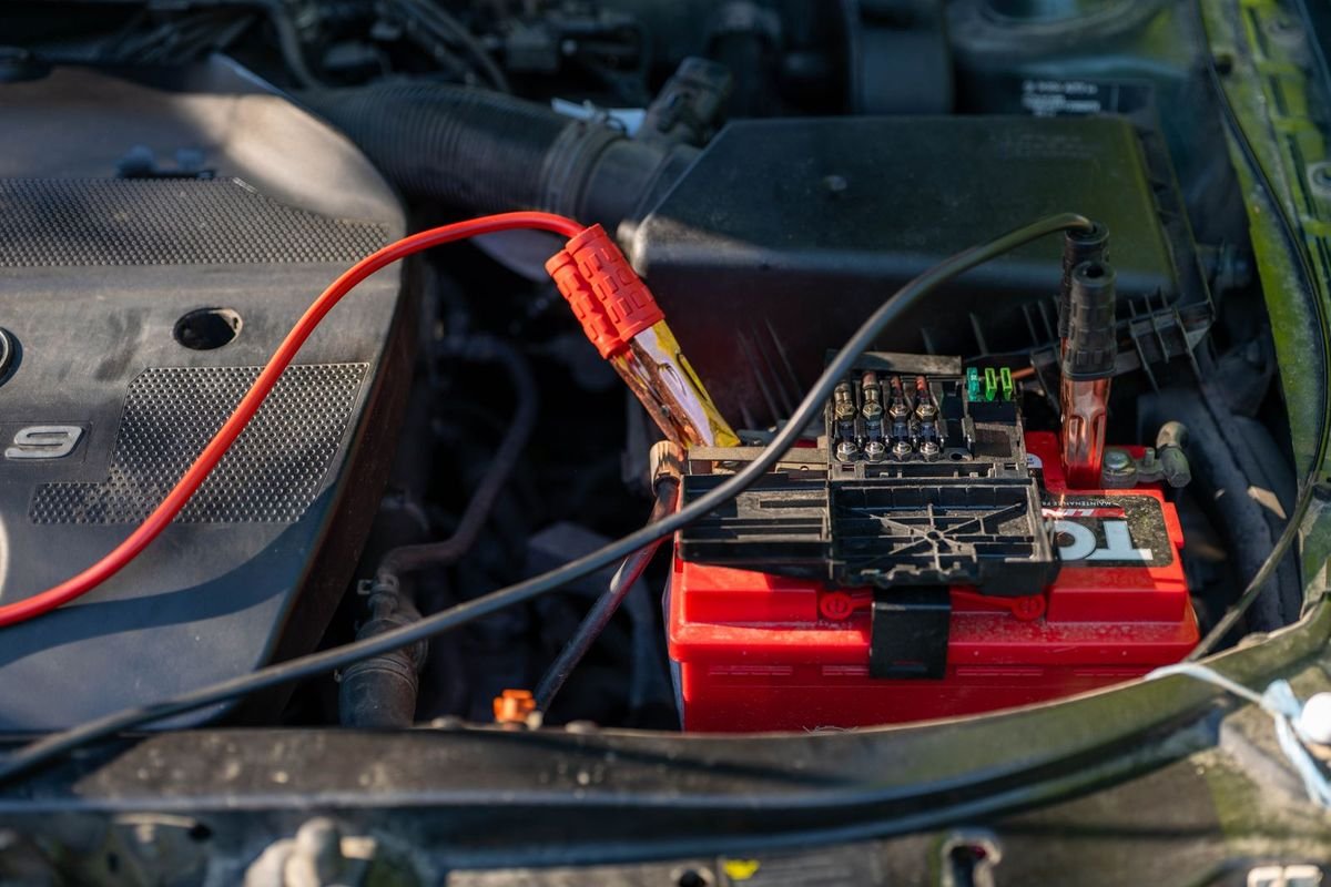 Car battery with jumper cables attached (representative photo, not the exact product)