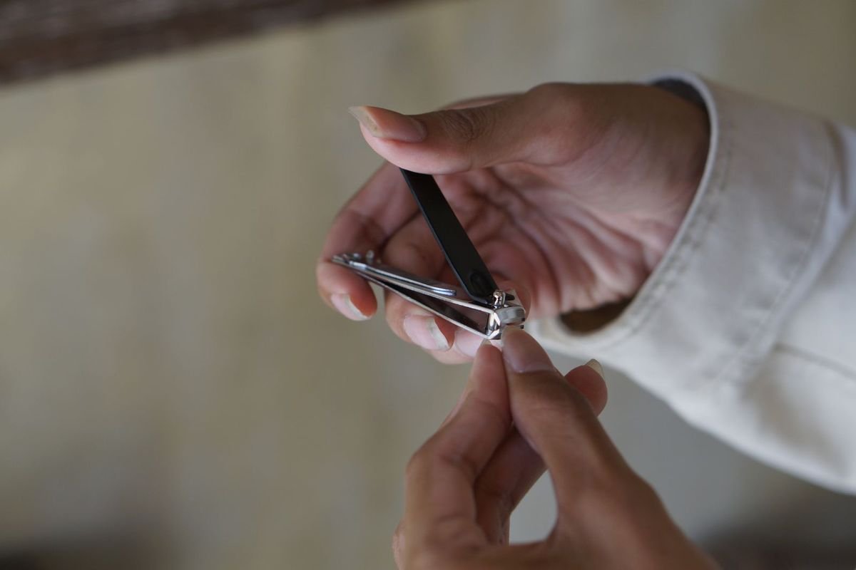 Man trimming his fingernails with nail clippers (representative photo, not the exact product)