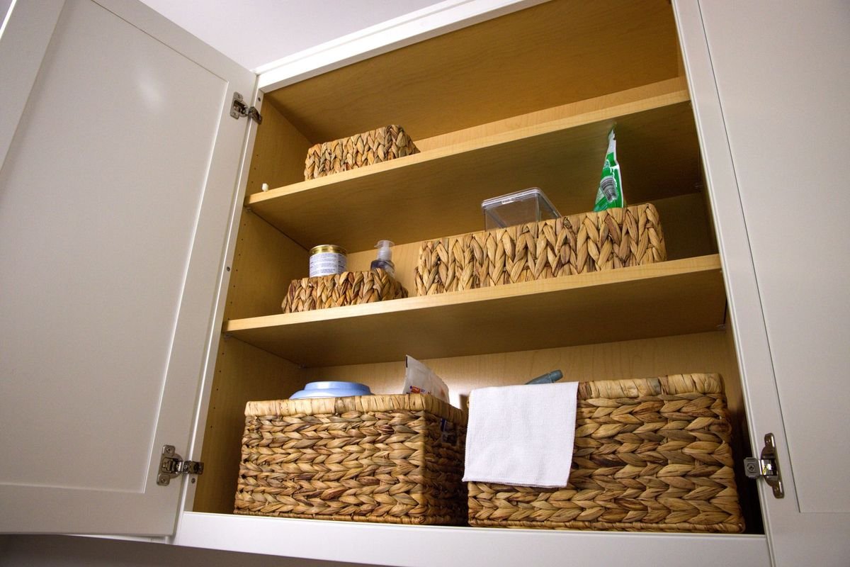 Organized kitchen cabinet with wicker baskets (representative photo, not the exact product)