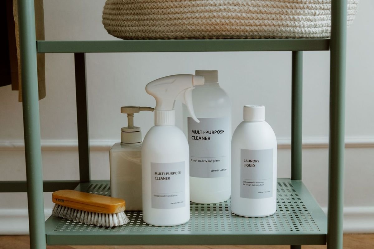 Bottles of cleaning products on a metal shelf (representative photo, not the exact product)