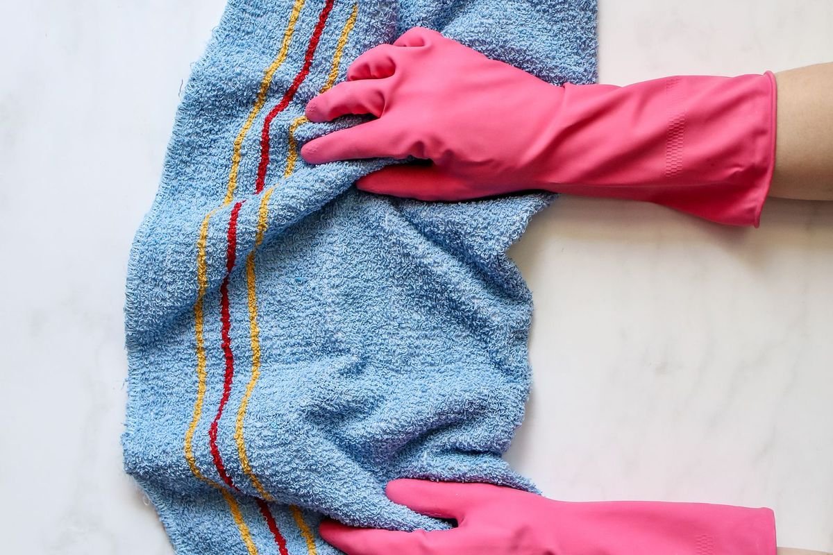 Wiping a marble countertop with a cleaning cloth (representative photo, not the exact product)